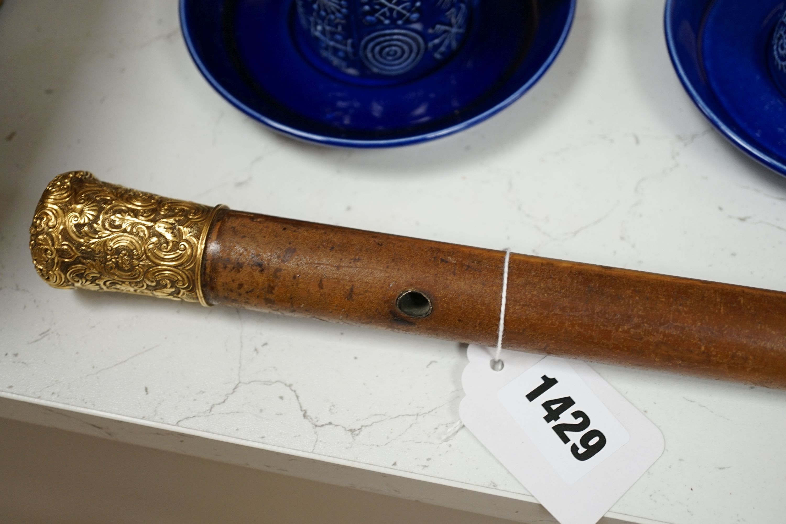 A 19th century malacca walking cane, with embossed yellow metal mount, 95cm.
